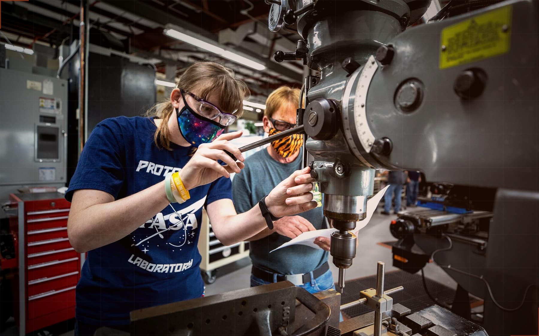 Technicians setting up a milling machine
