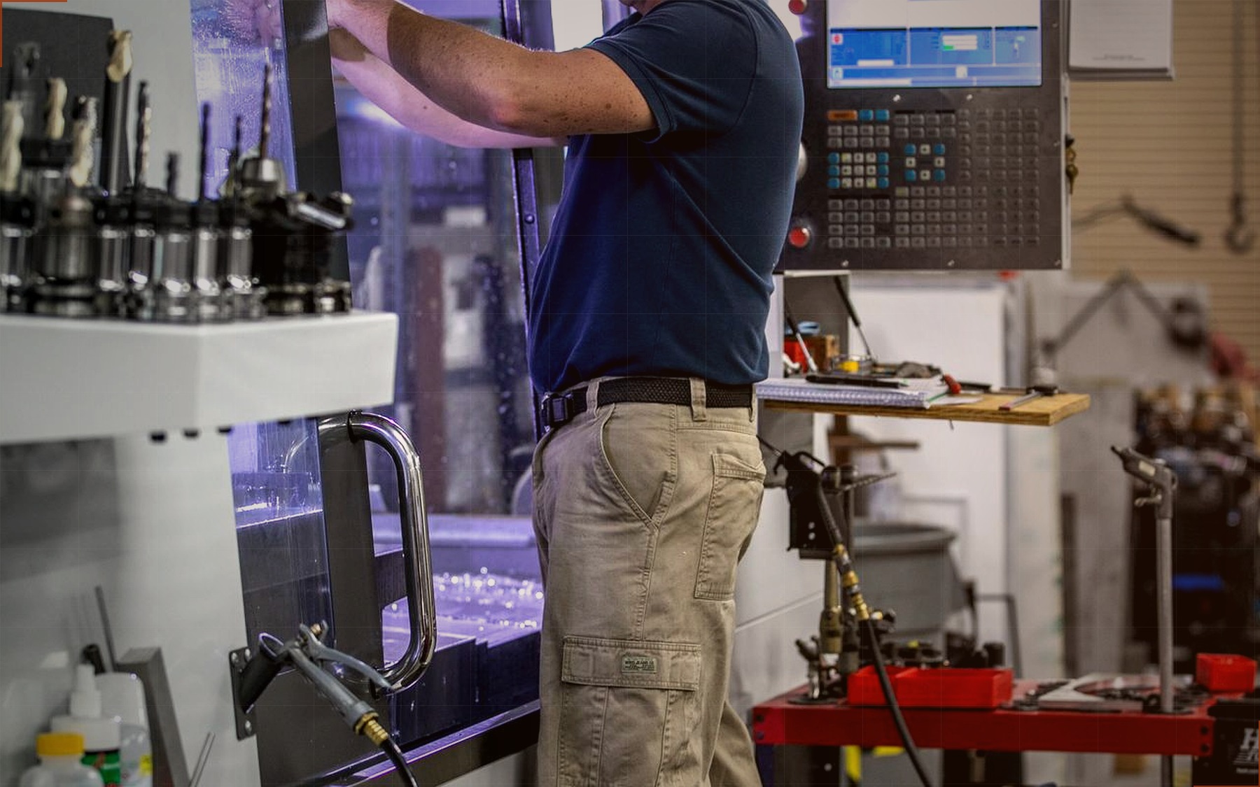 Machinist operating a CNC machining center